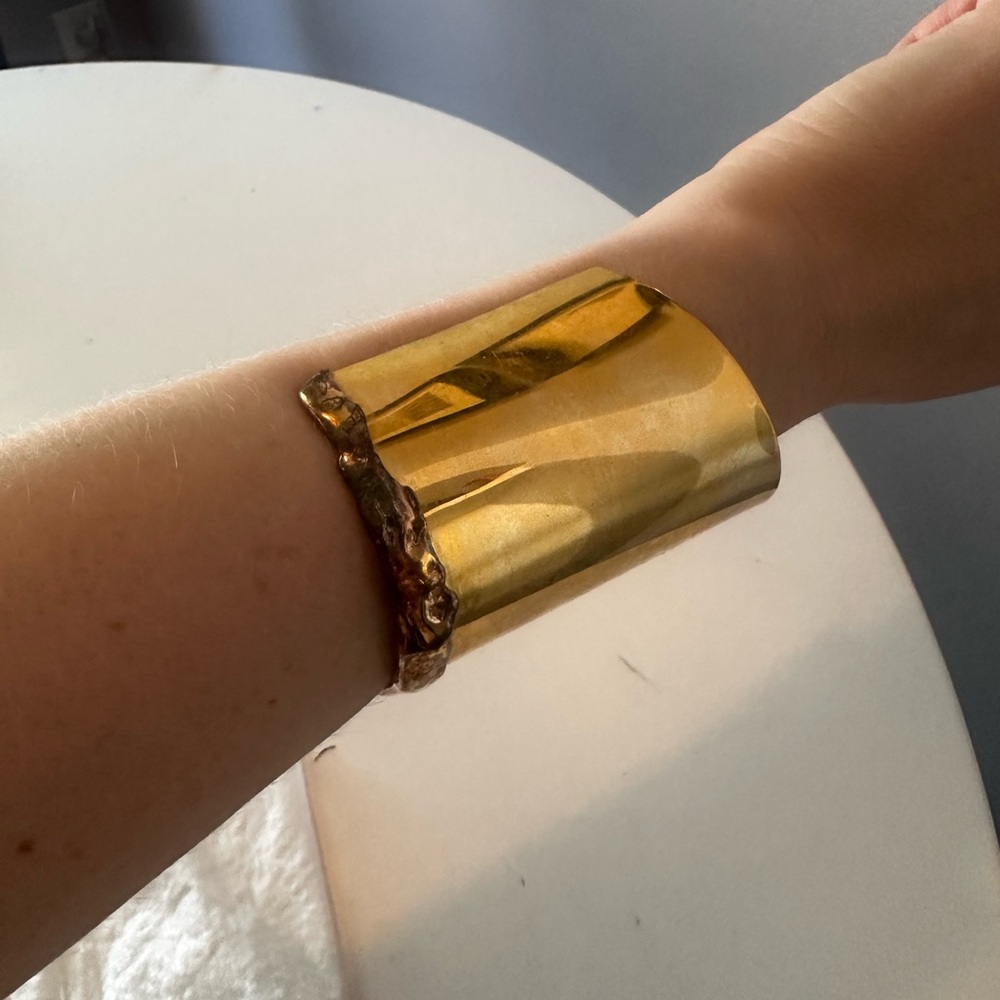 Gold cuff by Alexis Bittar